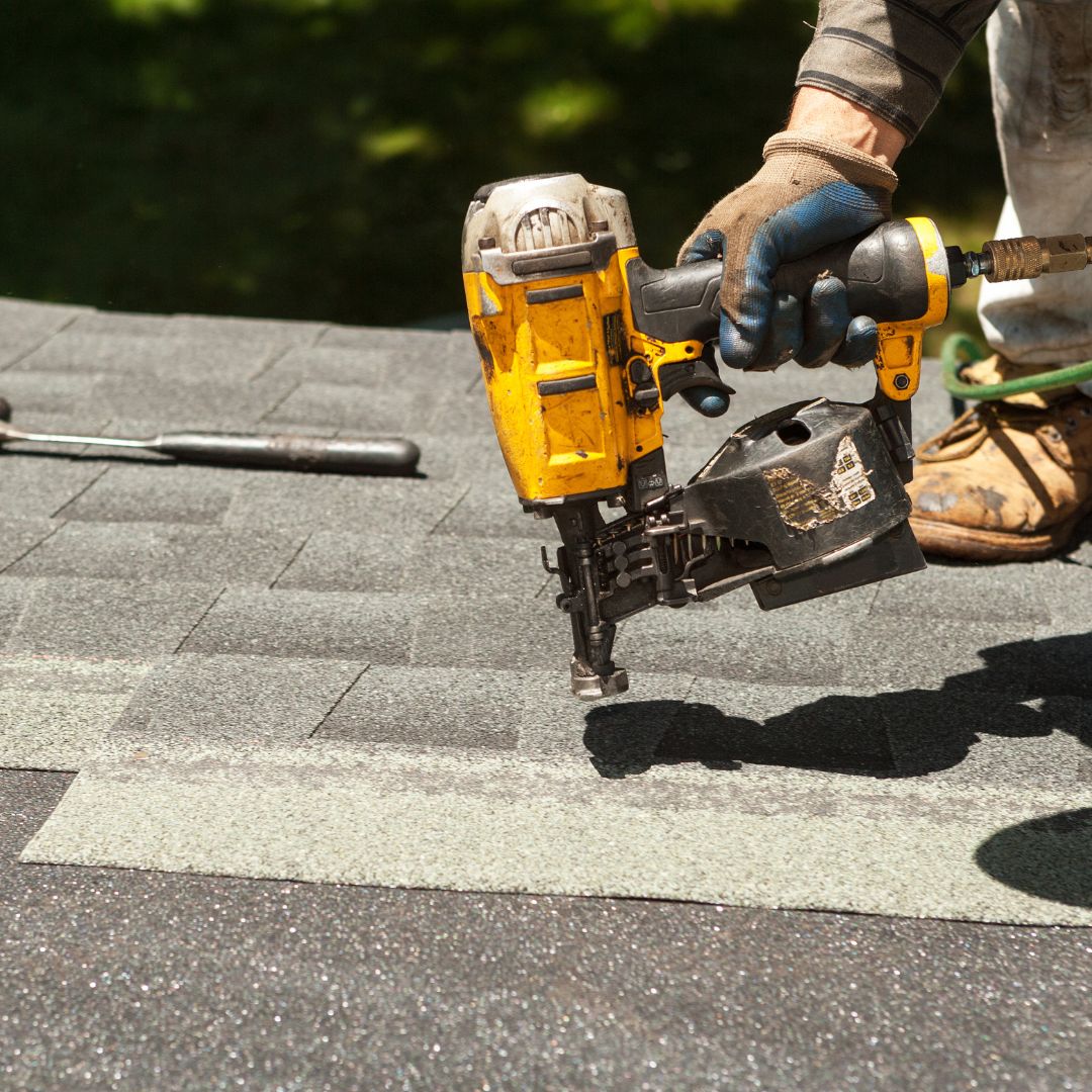a person using roofing tools